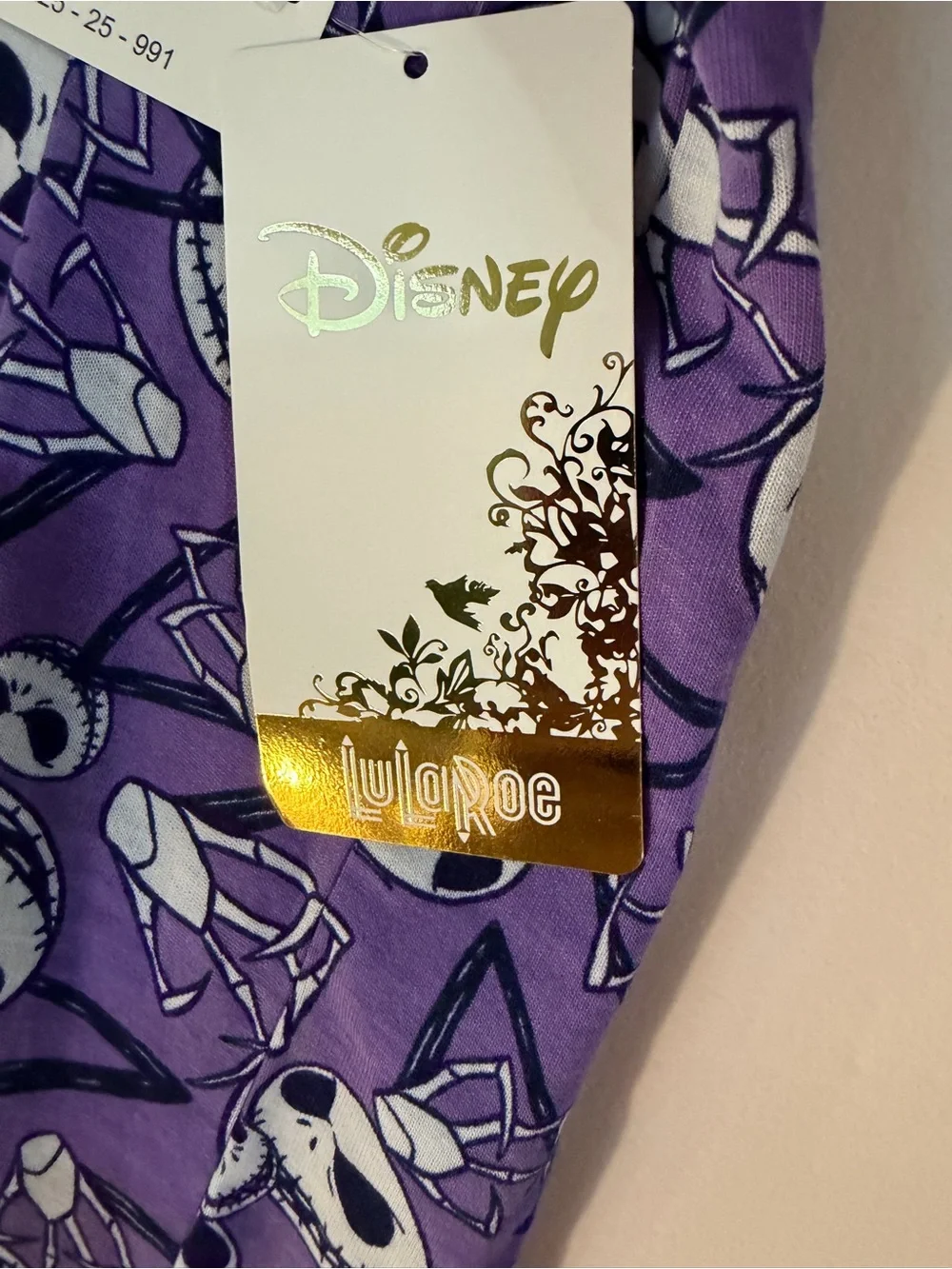 LuLaRoe Purple Short Sleeve Shirt with Black & White Skull Faces